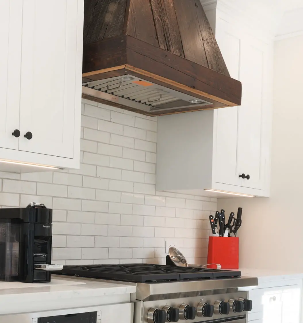 A reclaimed wood hood provides contrast